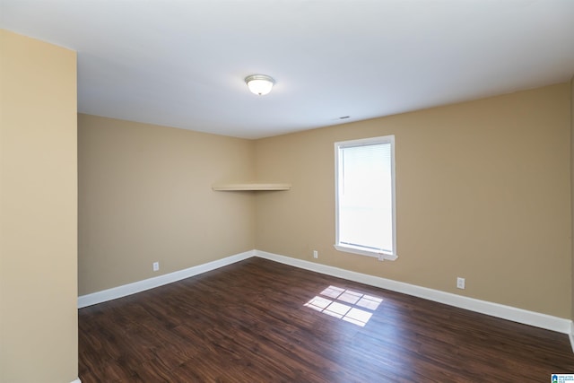 empty room with dark wood-type flooring