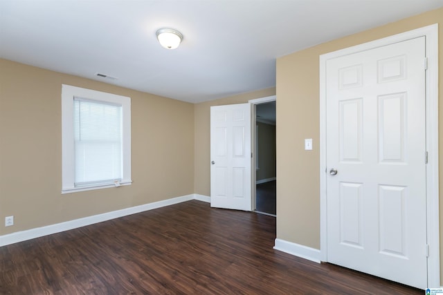 spare room with dark wood-type flooring