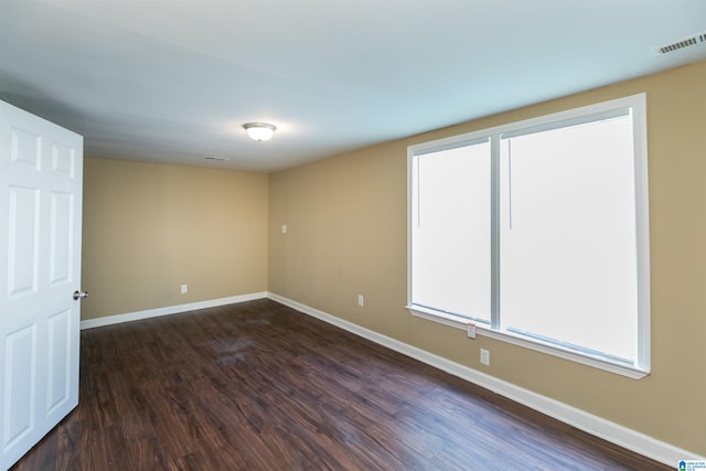 spare room featuring dark hardwood / wood-style flooring