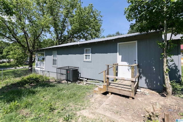 rear view of property with central AC