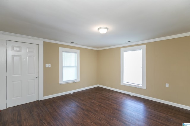 empty room with crown molding and dark hardwood / wood-style floors