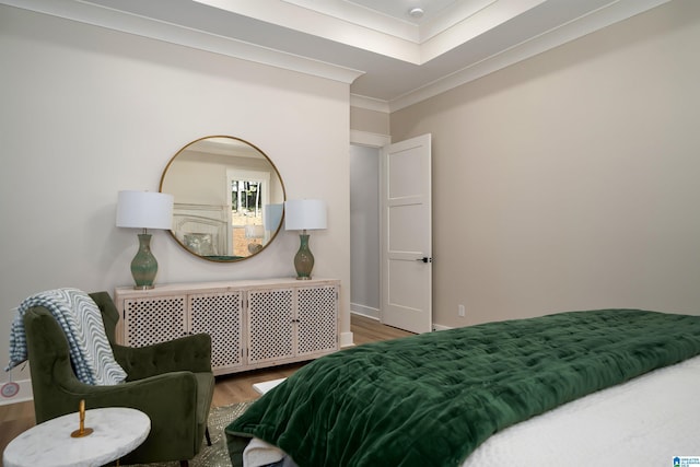 bedroom with ornamental molding, baseboards, and wood finished floors