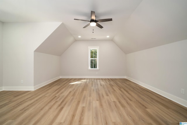 additional living space featuring ceiling fan, light wood-style flooring, recessed lighting, lofted ceiling, and baseboards