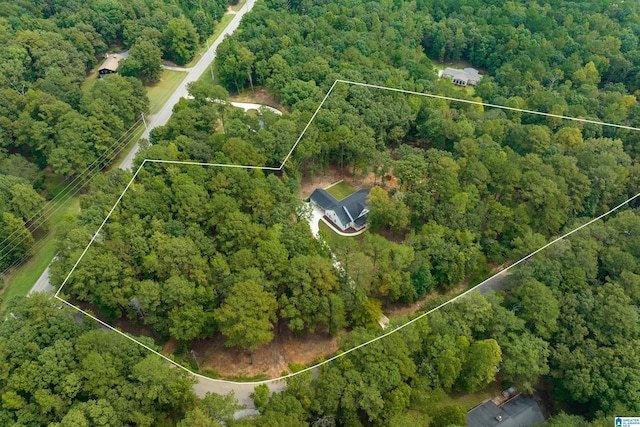 birds eye view of property with a wooded view