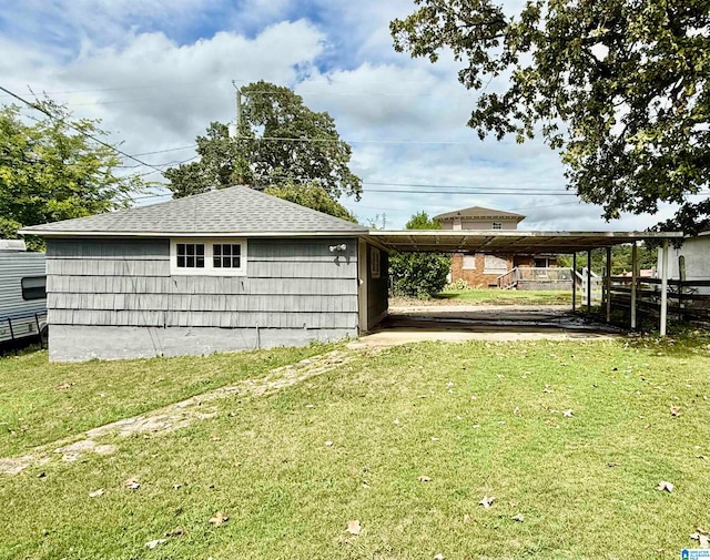 view of outbuilding with a yard and a carport