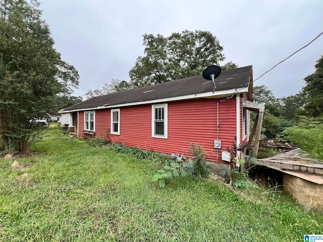 view of property exterior with a yard