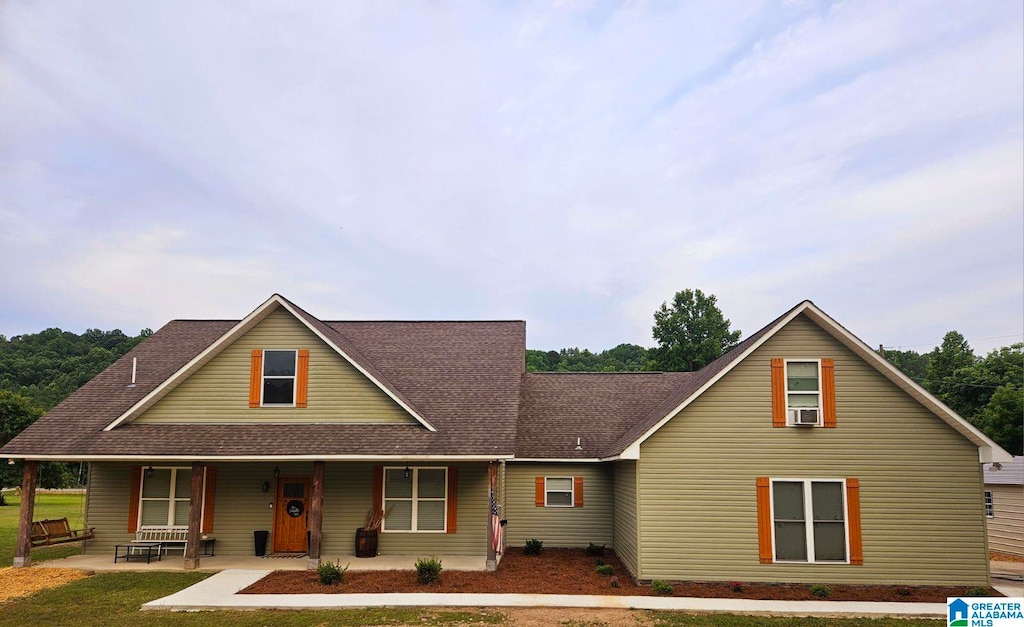 view of front facade featuring cooling unit and a porch