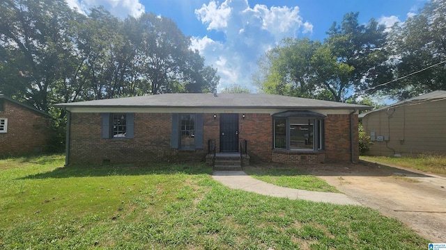 view of front of property with crawl space, concrete driveway, a front yard, and brick siding