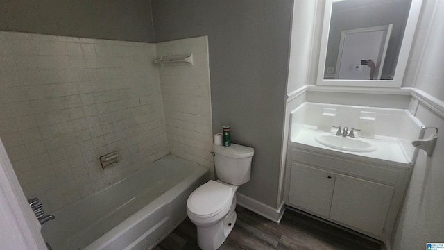 full bath featuring shower / bathtub combination, vanity, toilet, wood finished floors, and baseboards