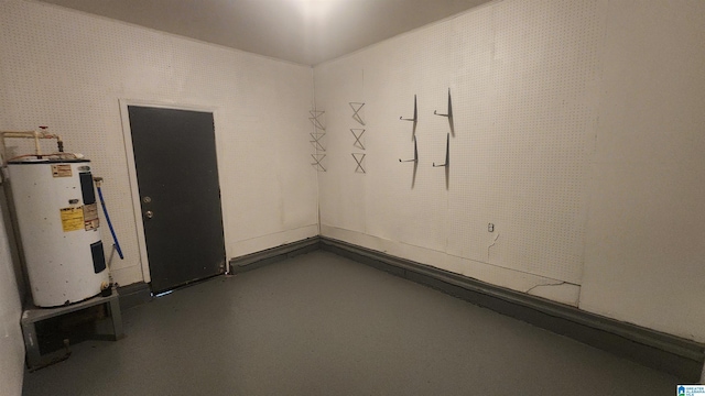 interior space with finished concrete flooring and water heater