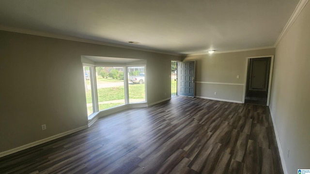 spare room featuring dark hardwood / wood-style floors and ornamental molding