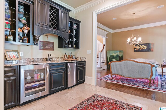 bar with wine cooler, a chandelier, stainless steel refrigerator, light hardwood / wood-style flooring, and crown molding