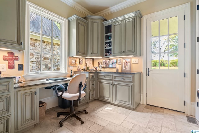 office with built in desk and ornamental molding