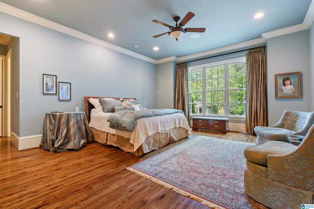 bedroom with light wood-type flooring, crown molding, and ceiling fan