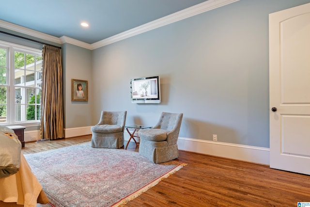 living area with ornamental molding and wood-type flooring