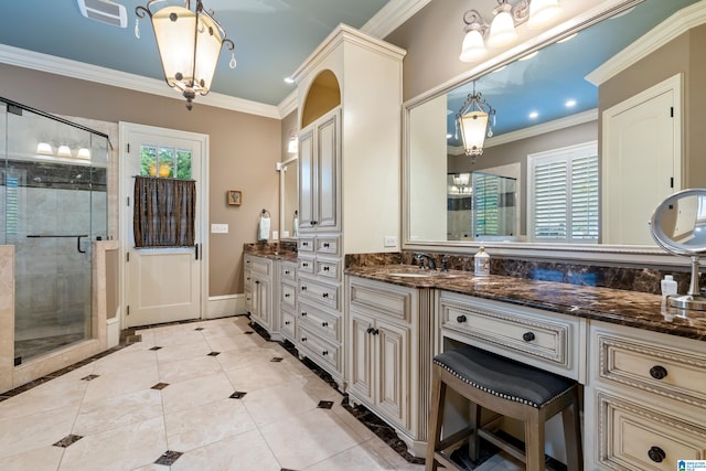 bathroom with a shower with door, vanity, and crown molding