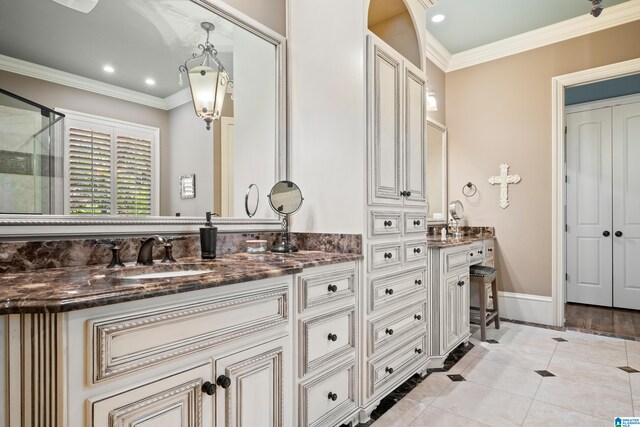 bathroom with ornamental molding, vanity, tile patterned flooring, and a shower with door