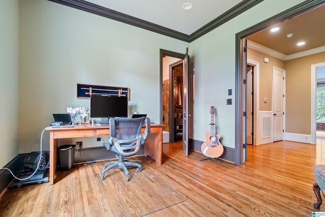 office with light hardwood / wood-style flooring and crown molding