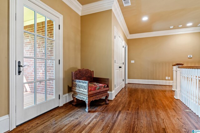 living area with crown molding and hardwood / wood-style floors