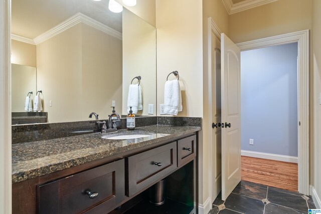 bathroom featuring vanity, crown molding, and hardwood / wood-style floors