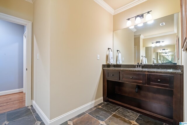 bathroom with crown molding and vanity