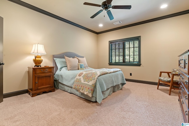 carpeted bedroom with ornamental molding and ceiling fan