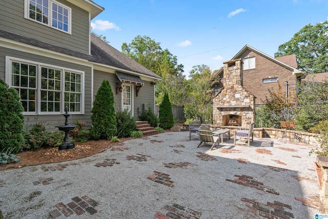 view of patio with an outdoor stone fireplace