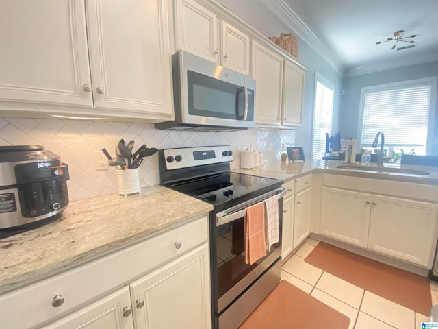 kitchen featuring white cabinets, stainless steel appliances, and sink