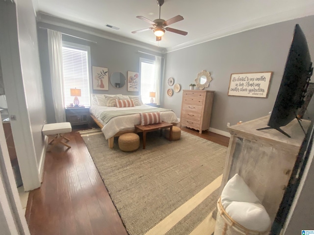 bedroom with ceiling fan, wood-type flooring, and crown molding