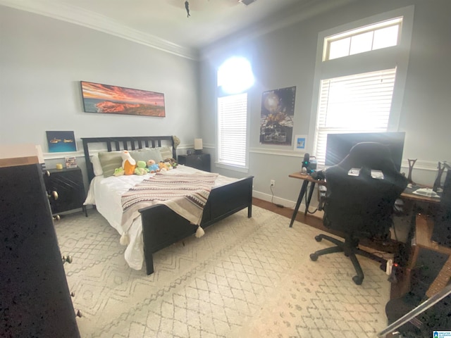 bedroom with crown molding and multiple windows