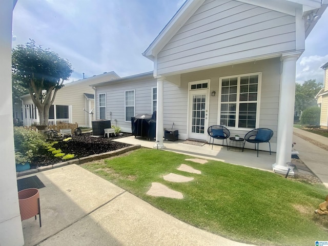 rear view of property featuring central AC unit and a yard