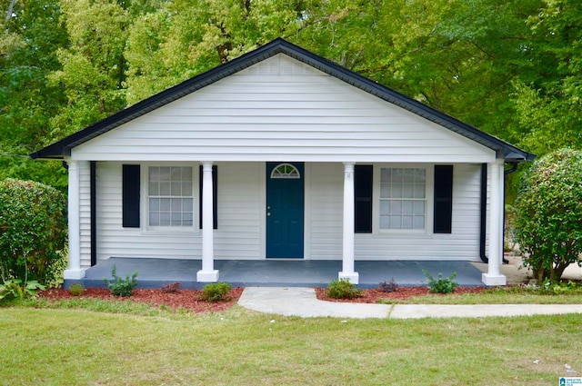 view of front of property with covered porch and a front yard