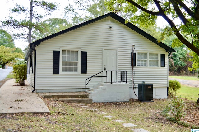 rear view of property with cooling unit