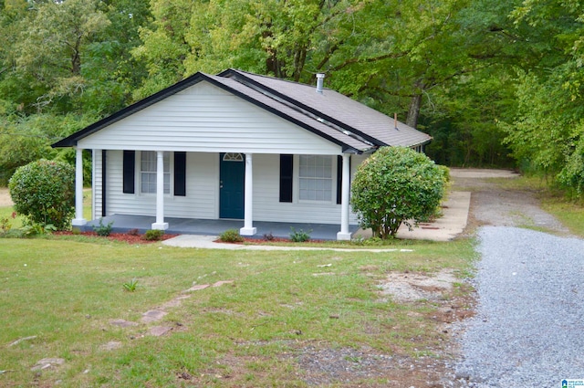 view of front of home with a porch and a front yard