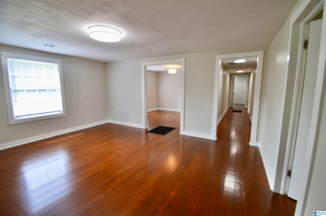 empty room with dark hardwood / wood-style floors