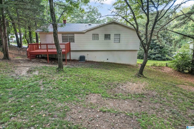 back of house featuring a wooden deck, a yard, and central AC