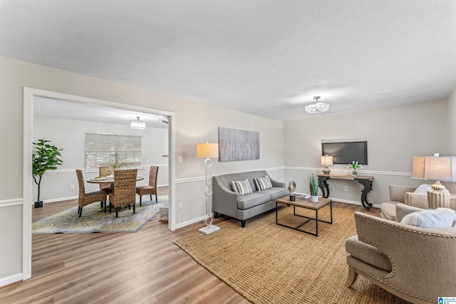 living room featuring a chandelier and hardwood / wood-style floors