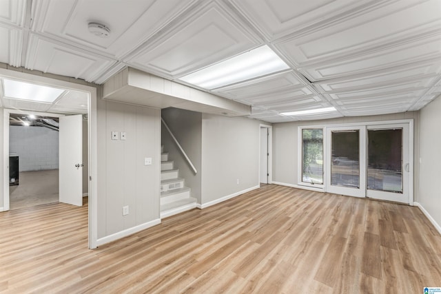 basement with light hardwood / wood-style flooring