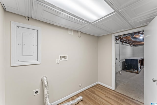 washroom featuring light hardwood / wood-style flooring, hookup for an electric dryer, electric panel, and washer hookup