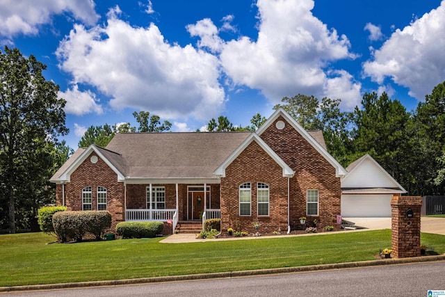 view of front of house featuring a front lawn, covered porch, and a garage