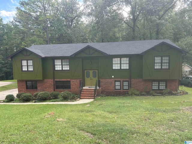 raised ranch with a front yard