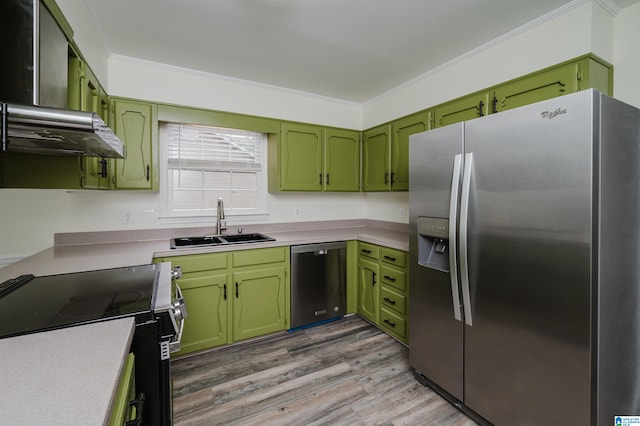 kitchen with light hardwood / wood-style floors, appliances with stainless steel finishes, and green cabinets