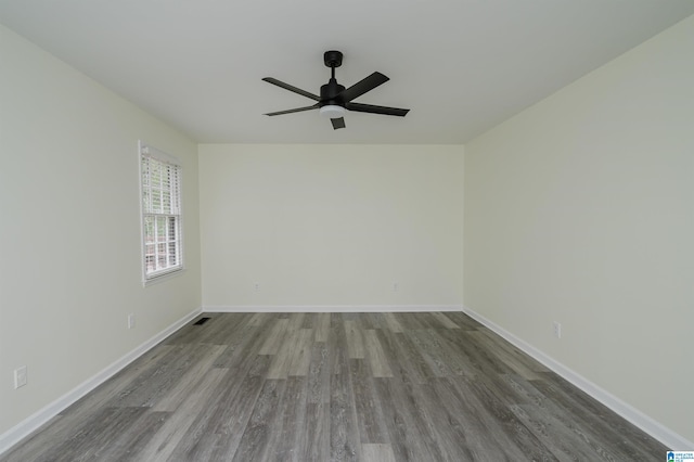 spare room featuring wood-type flooring and ceiling fan