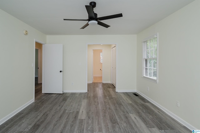 unfurnished room featuring ceiling fan and hardwood / wood-style flooring