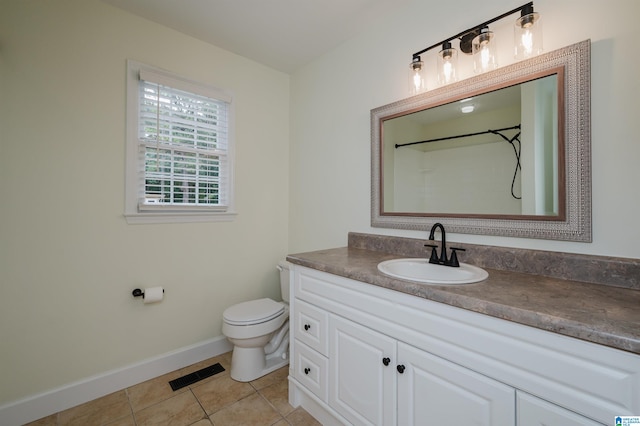 bathroom with tile patterned floors, vanity, and toilet