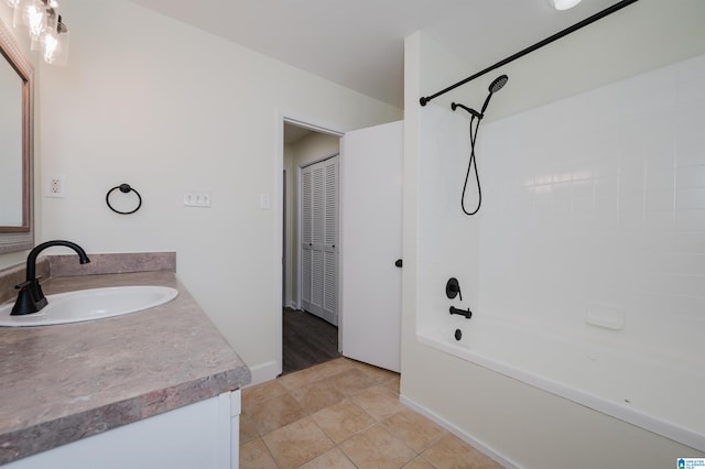 bathroom with tile patterned flooring, vanity, and  shower combination