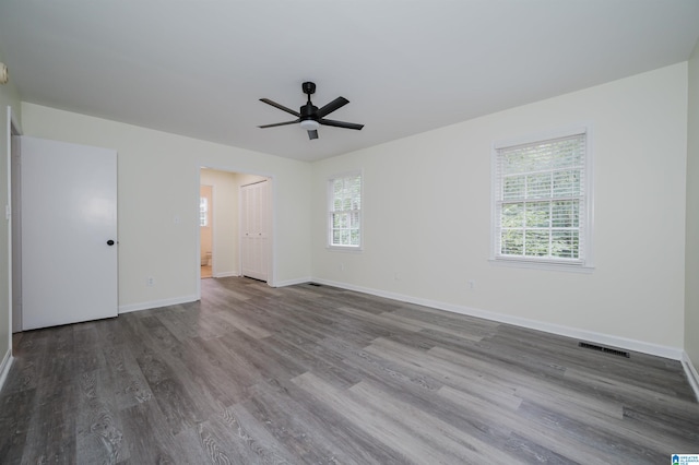 unfurnished bedroom with ceiling fan and wood-type flooring