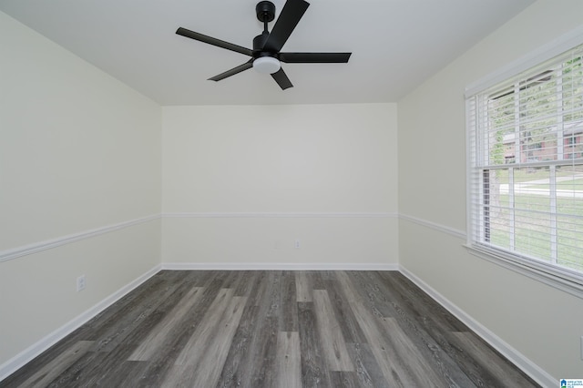 spare room featuring dark hardwood / wood-style flooring, a wealth of natural light, and ceiling fan