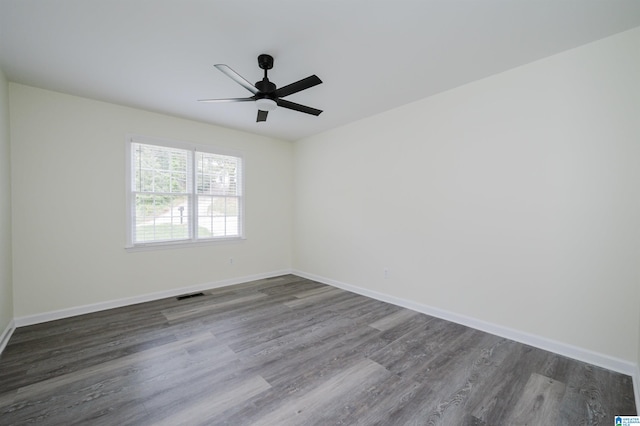 unfurnished room featuring dark hardwood / wood-style floors and ceiling fan