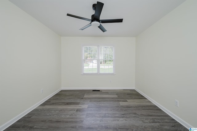 spare room featuring ceiling fan and dark wood-type flooring